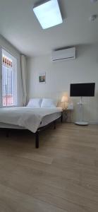 a bedroom with a bed and a flat screen tv at 1&2stayㅡH in Tongdaegu-yŏk