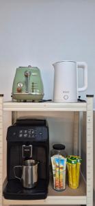 a shelf with a coffee maker and a microwave at 1&2stayㅡH in Tongdaegu-yŏk