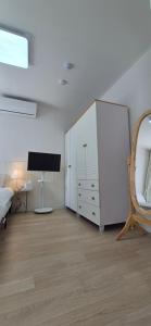a bedroom with a bed and a dresser and a mirror at 1&2stayㅡH in Tongdaegu-yŏk +11 photos