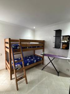 a room with two bunk beds and a ladder at Man Wee Apprt in Tangier