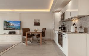 a kitchen with a table and chairs in a room at Princess in Binz