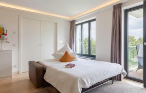 a hotel room with a bed with a book on it at Princess in Binz