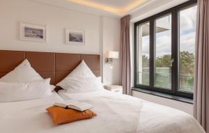 a hotel room with a bed with a book on it at Princess in Binz +34 photos