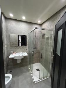a bathroom with a shower and a sink and a toilet at Man Wee Apprt in Tangier +13 photos