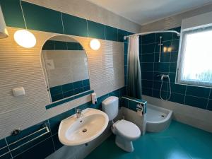 a bathroom with a sink and a toilet and a tub at Apartments MiaMaja 2 in Novalja +62 photos