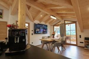 a kitchen and dining room with a table and chairs at Haus Hochlenzerblick in Schönau am Königssee