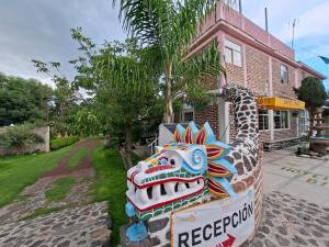 a dragon statue in front of a house at Hotel Fer in San Juan Teotihuacán +12 photos
