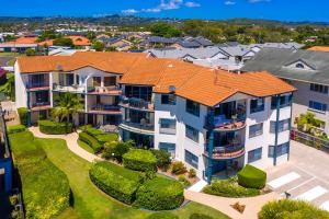 an aerial view of a large apartment building with an orange roof at Riverfront 2BR Apt with Views, Balcony & Parking in Maroochydore