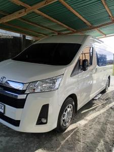 a white van parked under a building at Blue Rose Resort & Dive Center in Pattimura Airport +2 photos