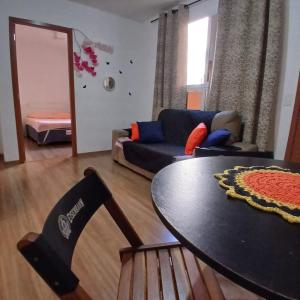 a living room with a table and a couch at Apartamento Harmonia! in Uberaba