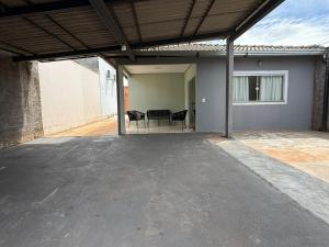 an open garage with a table and chairs in it at Casa parque 18 in Araguaína