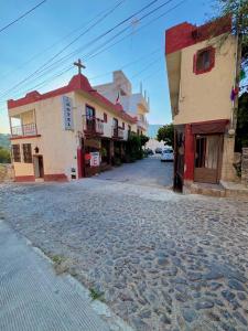 a cobblestone street in a town with buildings at Hotel Casa de Los Abuelos in Bernal