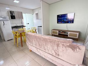 a kitchen with a couch in the middle of a room at Casa parque 18 in Araguaína