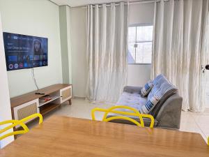 a living room with a couch and a table at Casa parque 18 in Araguaína