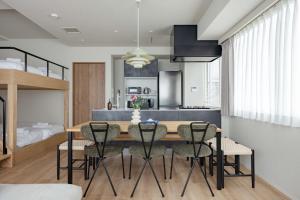 a kitchen and dining room with a table and chairs at SoMA Kagurazaka in Tokyo
