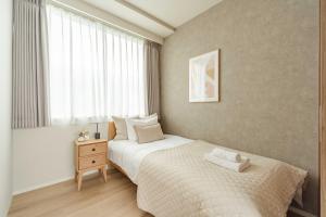 a small bedroom with a bed and a window at SoMA Kagurazaka in Tokyo +35 photos