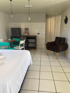 a room with a bed and a couch and a table at Cantinho da Nonna in Morretes +23 photos