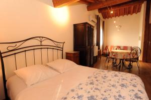 a bedroom with a bed and a table at Domaine de Nidolères in Tresserre +36 photos