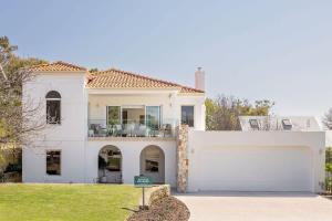 a white house with a large garage at Torretta by the Bay in Dunsborough