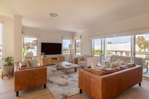 a living room with couches and a flat screen tv at Torretta by the Bay in Dunsborough +36 photos