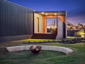 a house with a vase in the middle of a yard at Samphire Chalet Peppermint - Experience Eco-Luxury in Geographe