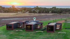 a group of modular homes on a grass field at Samphire Chalet Peppermint - Experience Eco-Luxury in Geographe +12 photos