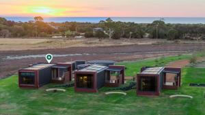 a group of modular houses on a grass field at Samphire Chalet Tuart - Luxury Amidst Nature in Geographe
