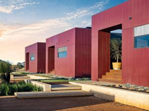 a pair of red buildings with a sky at Samphire Chalet Tuart - Luxury Amidst Nature in Geographe +14 photos
