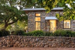 a stone house with windows and a stone wall at Petra Olive 1 in Yallingup