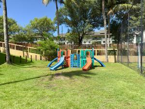 a playground with a slide in a park at Porto Beach Resort - Marulhos in Porto De Galinhas
