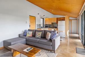 a living room with a couch and a table at Petra Olive 2 in Yallingup