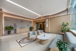 an office with a waiting room with chairs and a table at GH Hotel in Chengdu