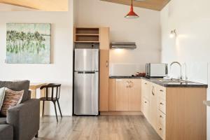 a kitchen with a stainless steel refrigerator in a room at Petra Olive 5 in Yallingup