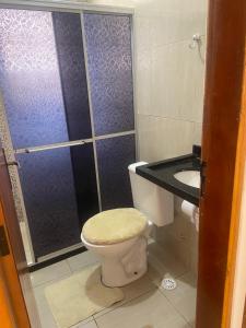 a bathroom with a shower and a toilet and a sink at Prive Familiar e Aconchegante in Paulista