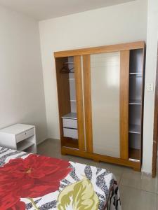 a bedroom with a bed and a dresser and a mirror at Prive Familiar e Aconchegante in Paulista