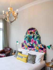 a bedroom with a bed with a colorful headboard at The High Field Town House in Birmingham