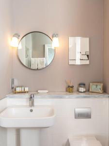 a bathroom with a sink, mirror, and bathtub at The High Field Town House in Birmingham