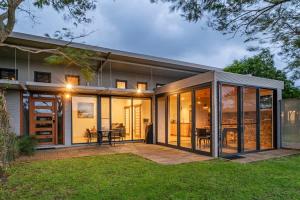 a house with large glass doors and a patio at Petra Olive 4 in Yallingup