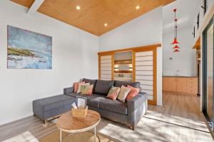a living room with a couch and a table at Petra Olive 4 in Yallingup
