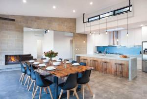 a kitchen with a large wooden table and chairs at Lake View - Contemporary Comforts meets Nature in Quindalup +11 photos