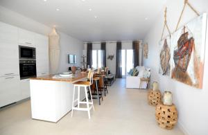 a kitchen and living room with a table and chairs at Lidia Villa in Panormos Mykonos