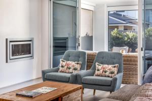 a living room with two chairs and a coffee table at Fernweh - A Generous Hamptons-style Beachside Escape in Geographe +30 photos