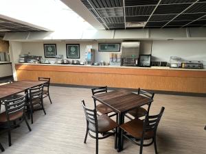 a restaurant with tables and chairs and a counter at Edgewater Hotel and Waterpark in Duluth