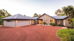 a house with a large driveway in front of it at Sky View - Elevated Estate with Resort-Style Pool in Yallingup