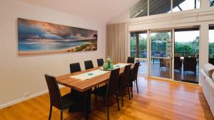 a dining room with a table and chairs at Sky View - Elevated Estate with Resort-Style Pool in Yallingup +29 photos