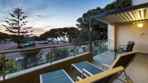 a balcony with chairs and a view of a street at Surfside 8 - Spacious Retreat on Yallingup Beach in Yallingup