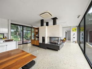a living room with a fireplace and a table at Sophie's Vineyard - Sprawling Scenery with Pool in Yallingup +35 photos