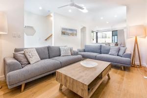 a living room with a couch and a coffee table at Yallingup Lagoon Beach House in Yallingup +31 photos