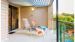 a balcony with chairs and a view of the ocean at Surfside 9 - In the Idyllic Yallingup Beach Scene in Yallingup