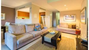 a living room with a couch and a table at Surfside 9 - In the Idyllic Yallingup Beach Scene in Yallingup +16 photos